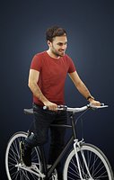 Flow A Caucasian Male Dressed In A Bordeaux Red T-Shirt Riding A Bicycle