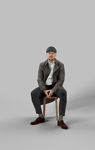 Sitting Man Business In A Winter Coat And A Newsboy Tweed Cap Master