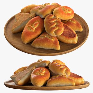 Baked pies on a wooden plate