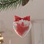 Heart-Shaped Christmas Ornament on Pine Branch