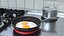 Nonstick Frying Pan with Fried Eggs on Red Silicone Mat 3D model