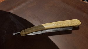 Vintage Straight Razor with Ornate Carved Handle