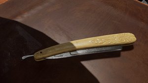 Vintage Straight Razor with Ornate Carved Handle