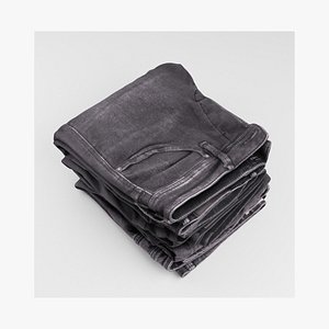 Pile or stock of folded black jeans pants for wardrobe