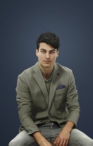 Prime Smart Casual Caucasian Male In Light Green Jacket And Grey Trousers Sitting And Observing