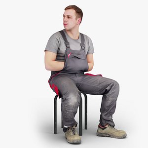 Resting Foreman Worker Sitting in Overalls
