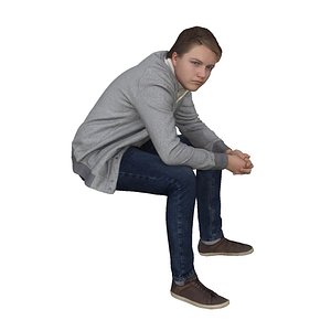 Boy in grey sweater sitting