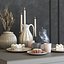 A set of dishes with cake, muffins and dried flowers