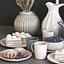 A set of dishes with cake, muffins and dried flowers