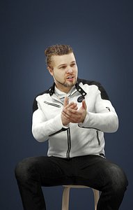 Keen A Caucasian Man In A White Jacket Sitting Explaining