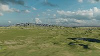 A folded terrain with a road running through it