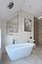Spacious bathroom with stone tiles