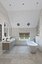 Spacious bathroom with stone tiles