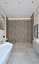 Spacious bathroom with stone tiles