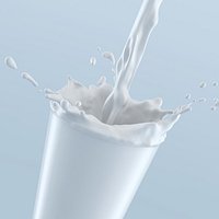 Liquid pouring into glass with splash