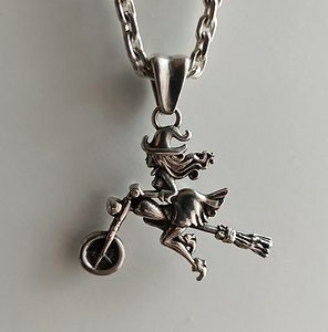 Witch pendant on motor broom