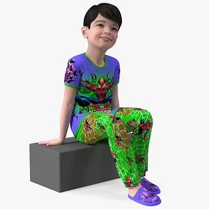 Sitting Asian Boy in Spiderman Pajamas