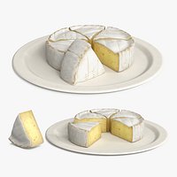 Soft Cheese Wheel with Cut Wedges on Plate