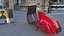 Roter Elektroroller Vespa 98 mit eingeschaltetem Licht geparkt