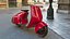 Roter Elektroroller Vespa 98 mit eingeschaltetem Licht geparkt