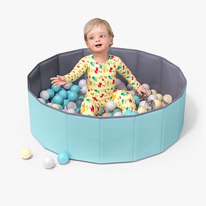 Baby Boy in a Folding Dry Pool with Balls