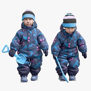 Cute child in overall with small plastic shovel