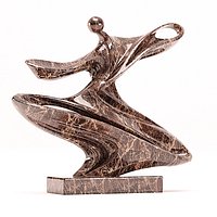 An abstract marble sculpture with a fluid streamlined design